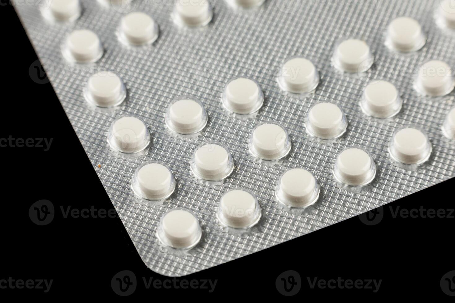 White pills in a transparent blister photo