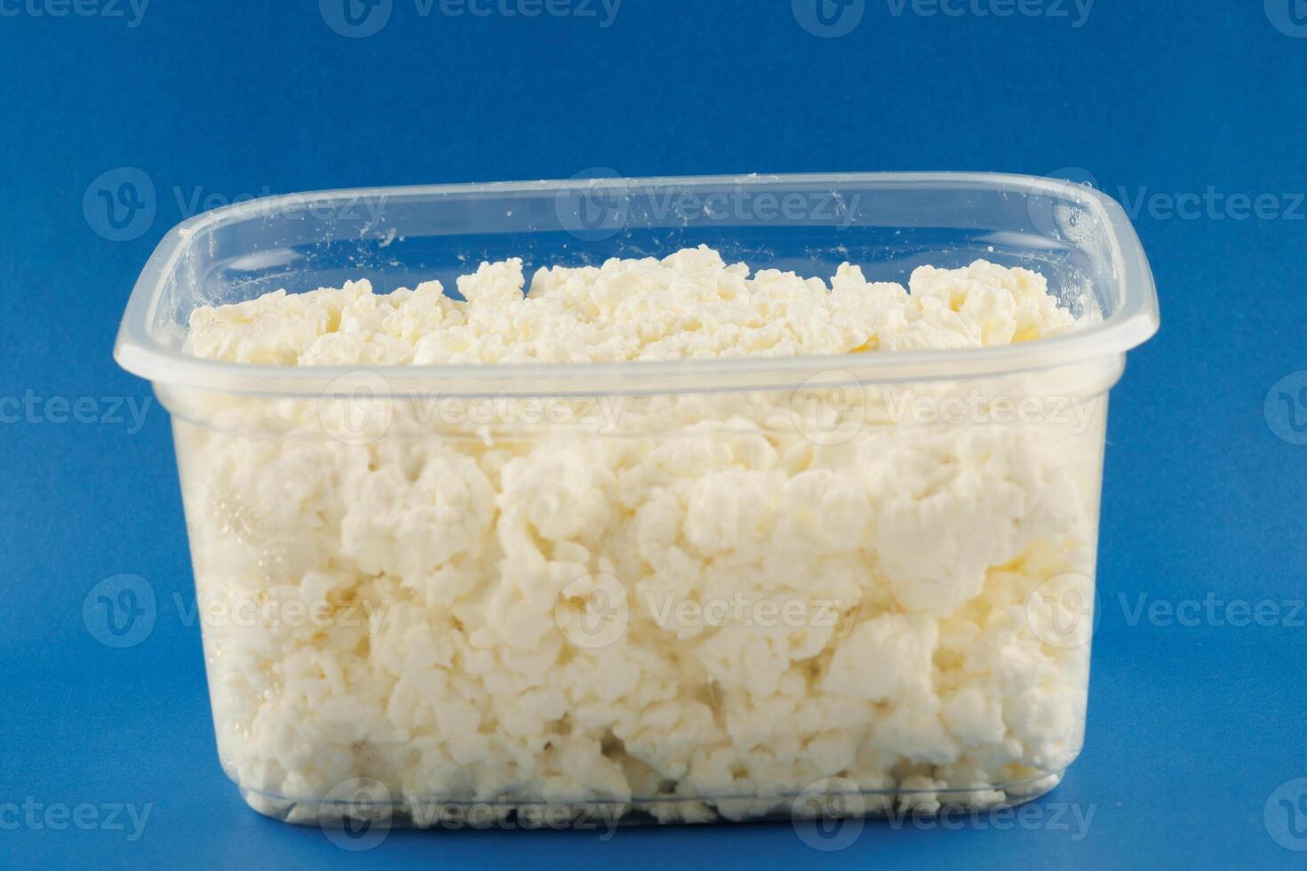 Cottage cheese in a plastic container photo