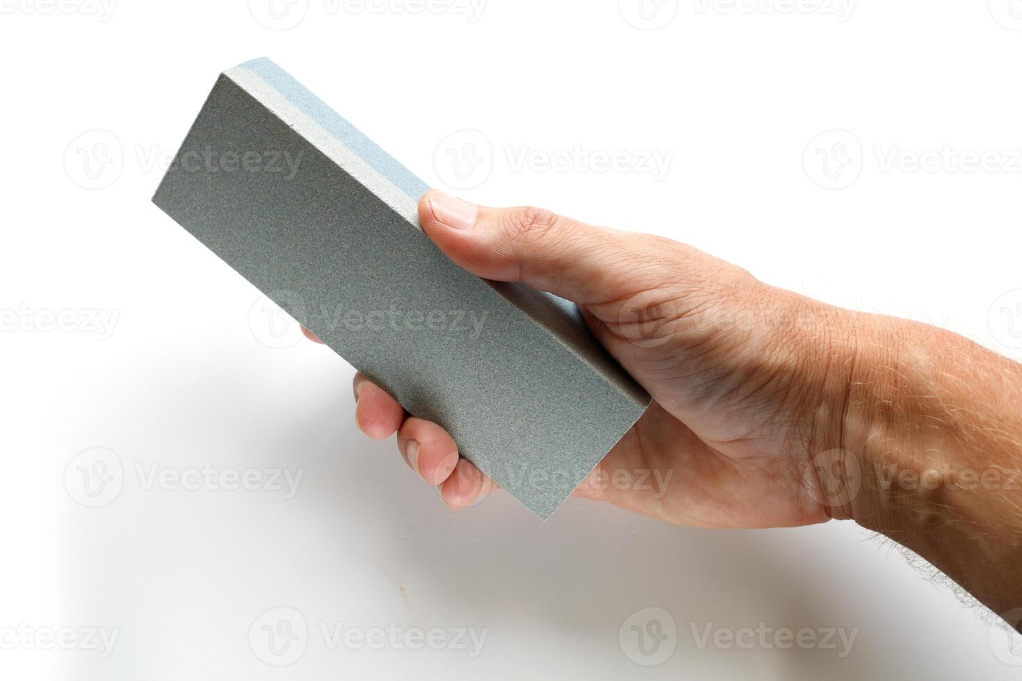 Knife sharpener in hand. Grinding bar photo