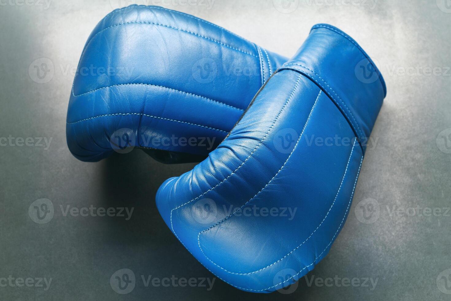 Blue boxing gloves on concrete photo