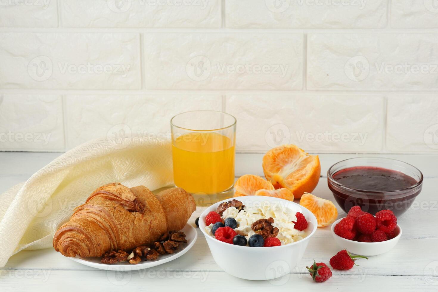 croissant breakfast with cheese, berries and nuts. Hearty and healthy food. photo