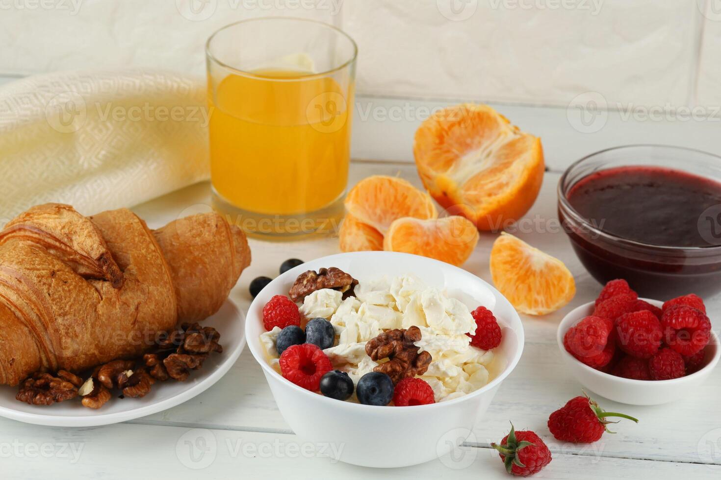 Breakfast with cheese and croissant. breakfast table with cheese, berries and croissant. Top view of breakfast photo