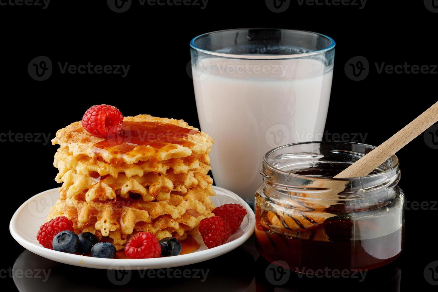 Belgian waffles with honey, yogurt and berries photo