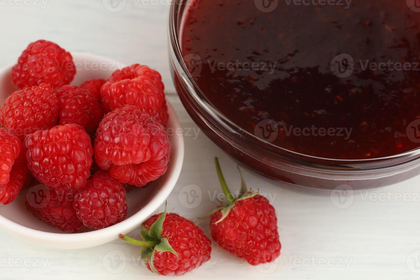 Raspberry jam in a glass vessel photo