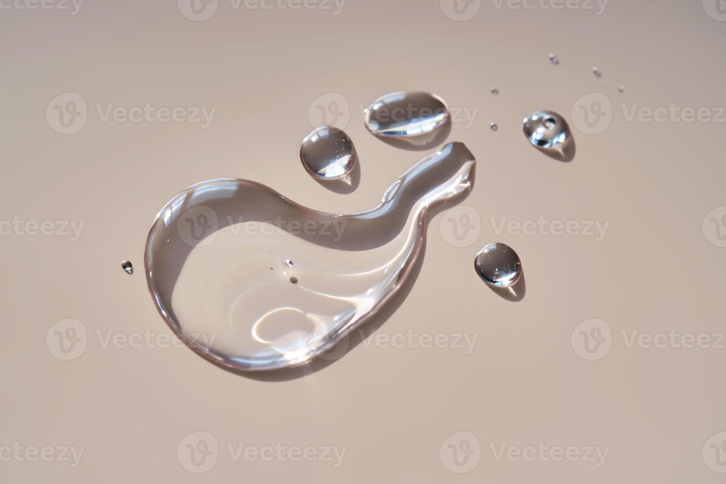 A drop of micellar water on a beige background. photo