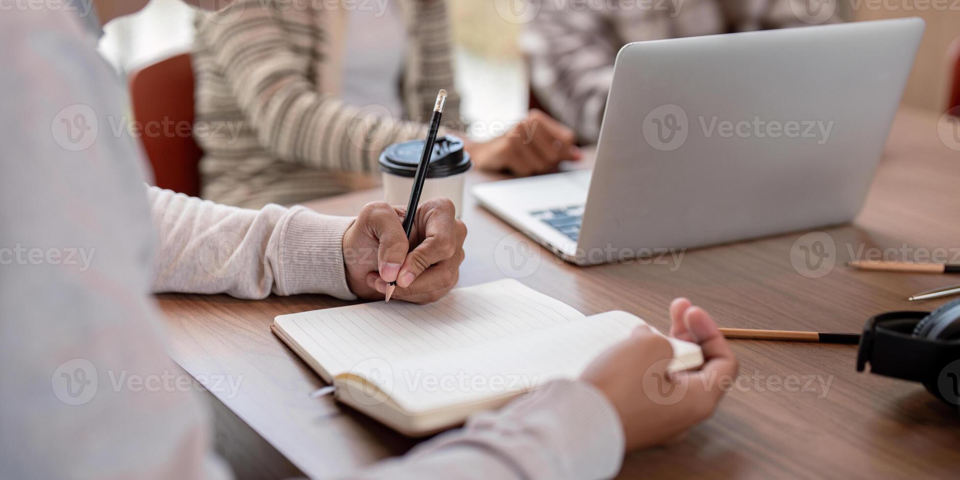 Focused Student Studying Together with Laptops and Notebooks in a Modern Classroom Setting photo
