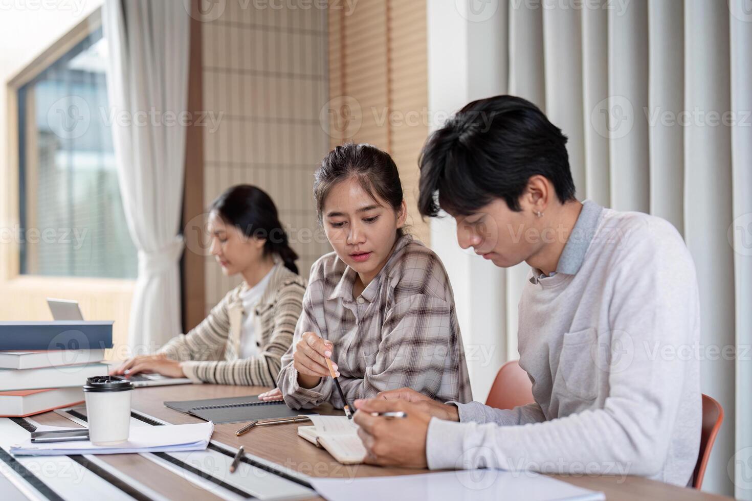 Focused Student Collaboration and Studying Together in a Modern Classroom Setting photo