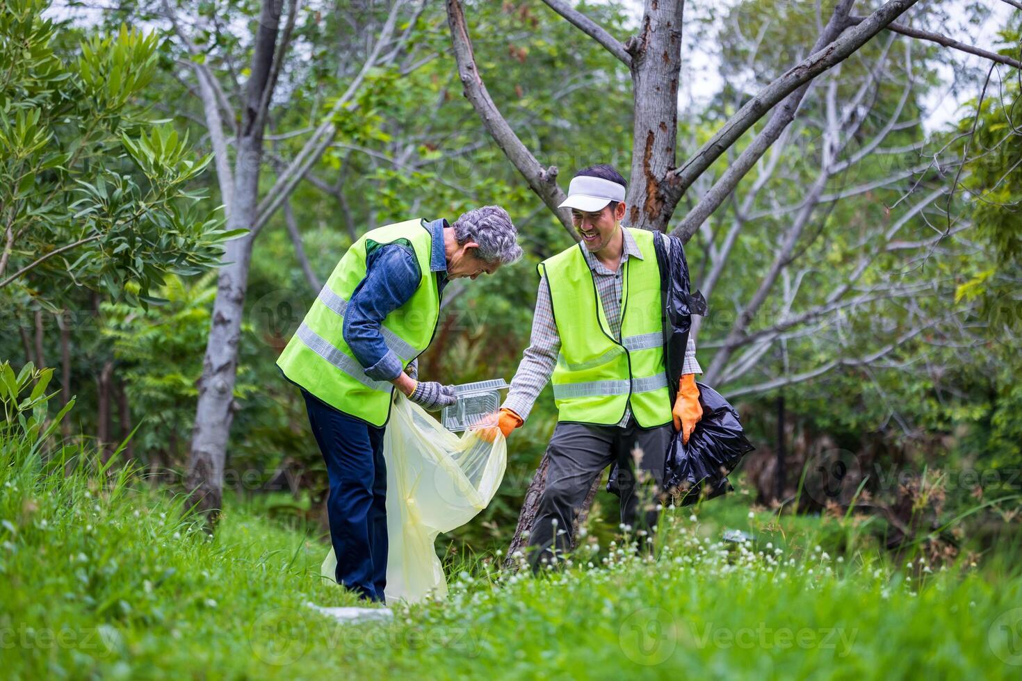 Team volunteer worker group enjoy charitable social work outdoor in cleaning up garbage and waste separation project at the park or natural forest for community service and recycle concept photo