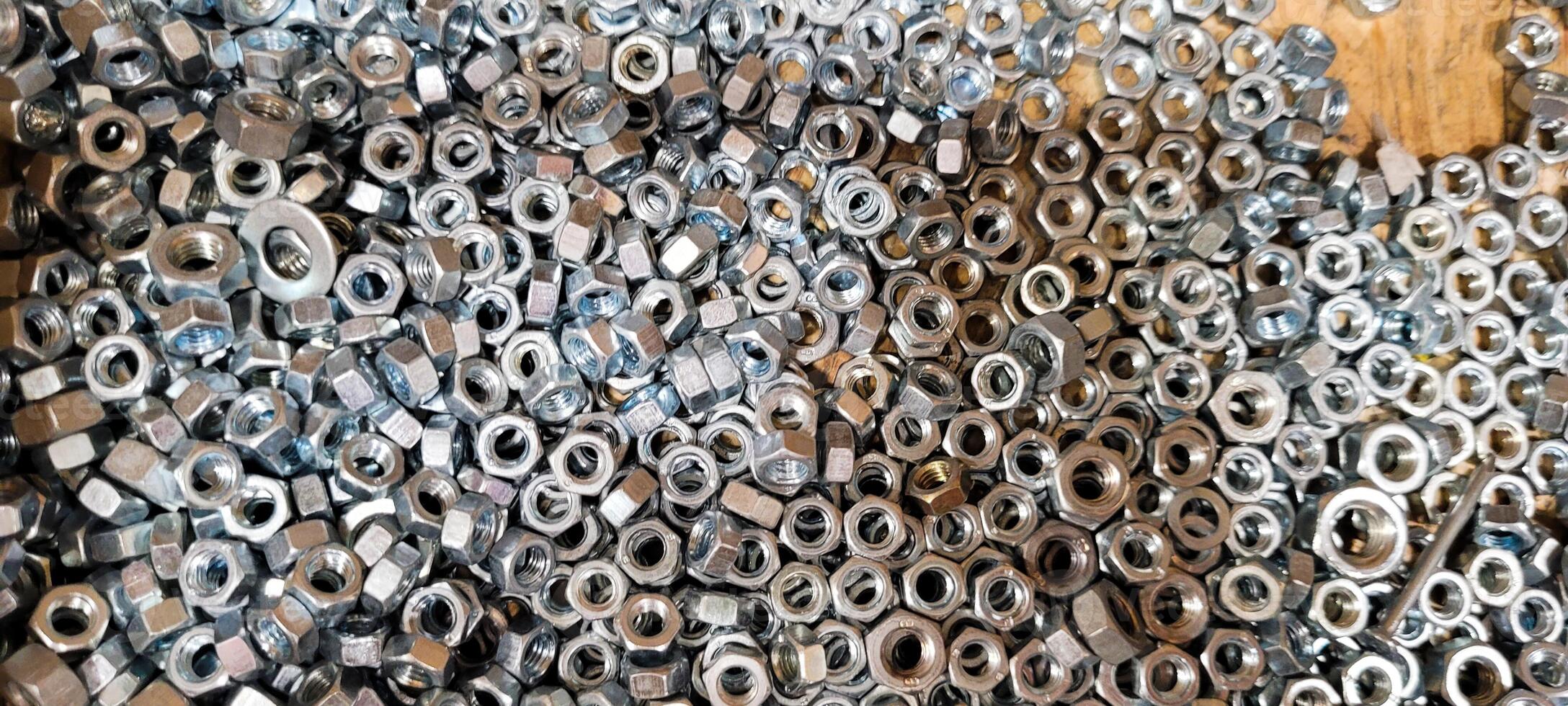 small metal nuts in wooden box photo
