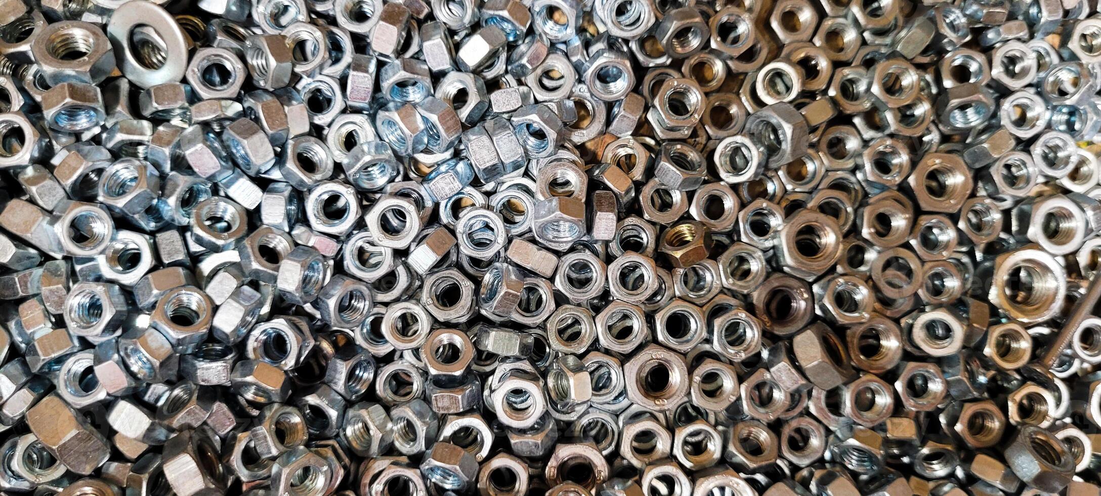 small metal nuts in wooden box photo