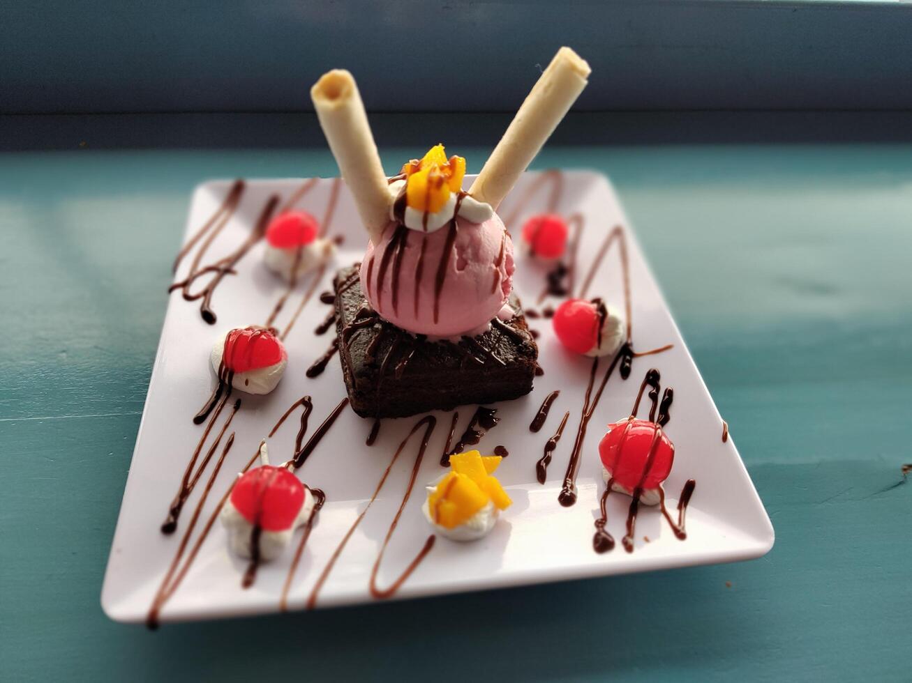 a dessert with chocolate and ice cream on a plate photo