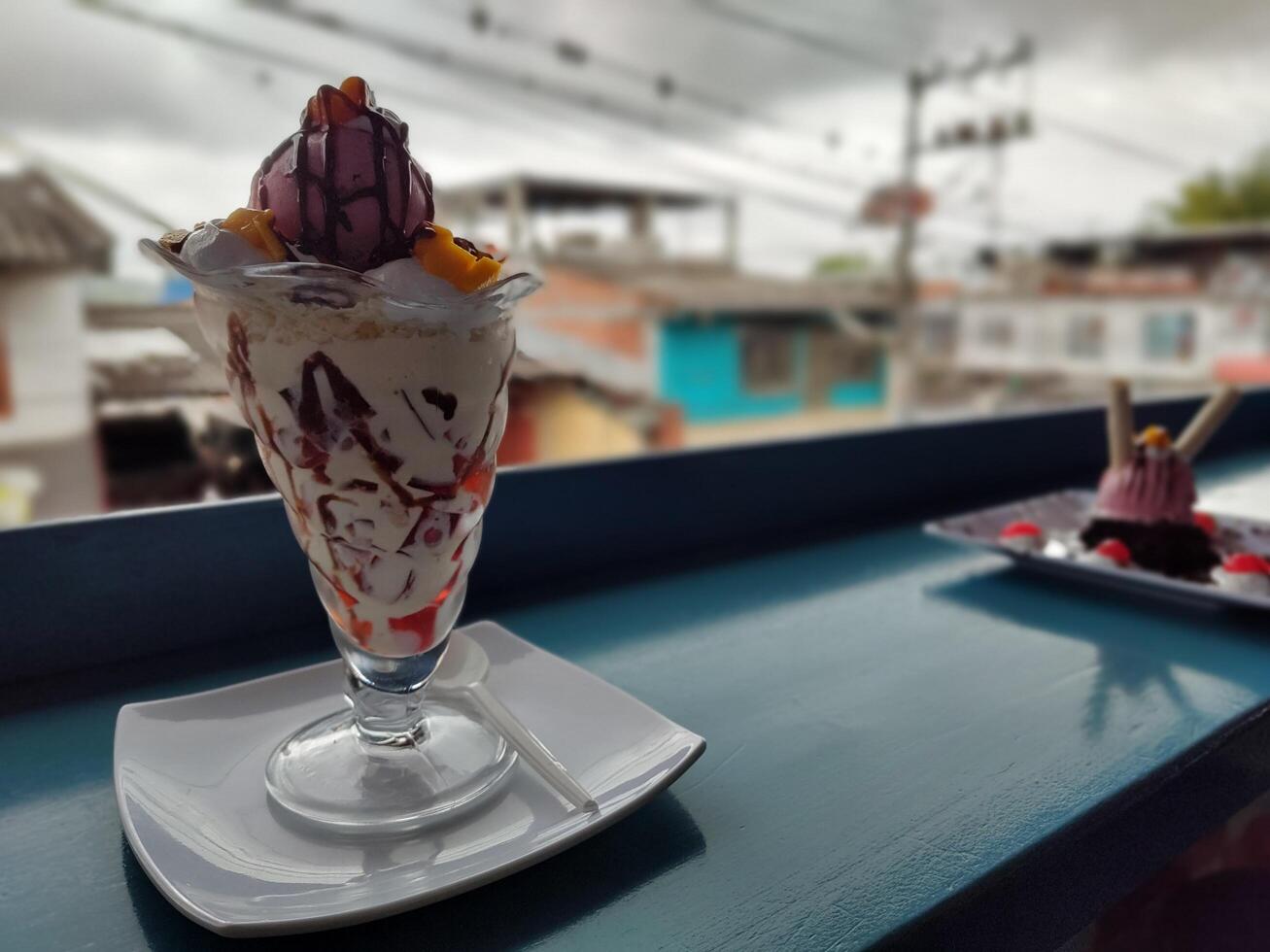 a dessert in a glass with a view of the city photo