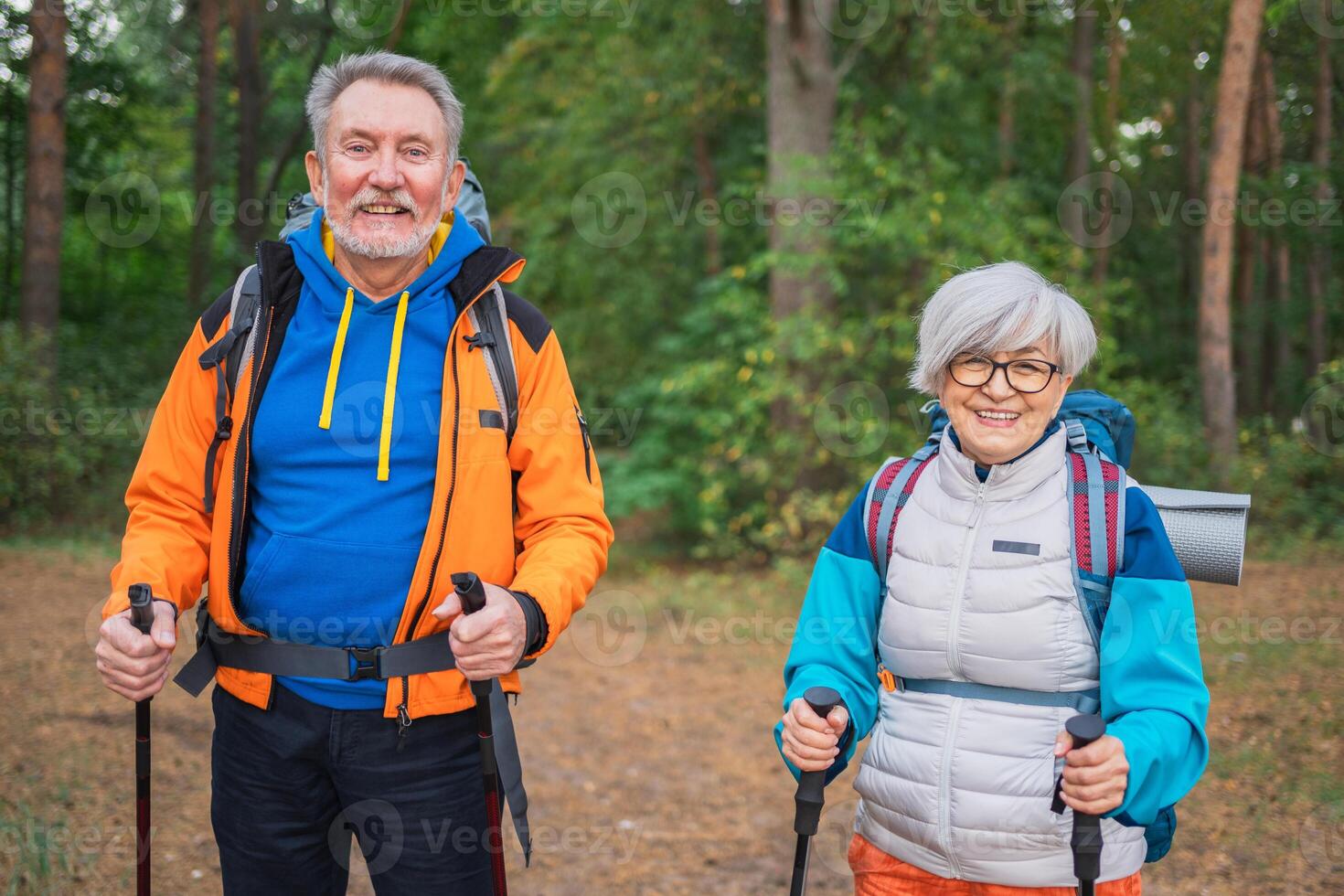 Hiking tourism adventure. Senior couple man woman enjoying outdoor recreation hiking in forest. Happy old people backpackers hikers enjoy walking hike trekking tourism active vacation beauty of nature photo