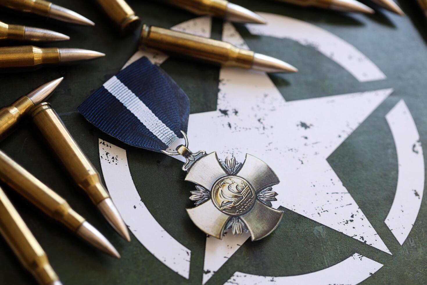 KYIV, UKRAINE - JULY 10, 2024 US Navy Cross medal. United States military award medal with ribbon and pin. Handmade paper theater props photo