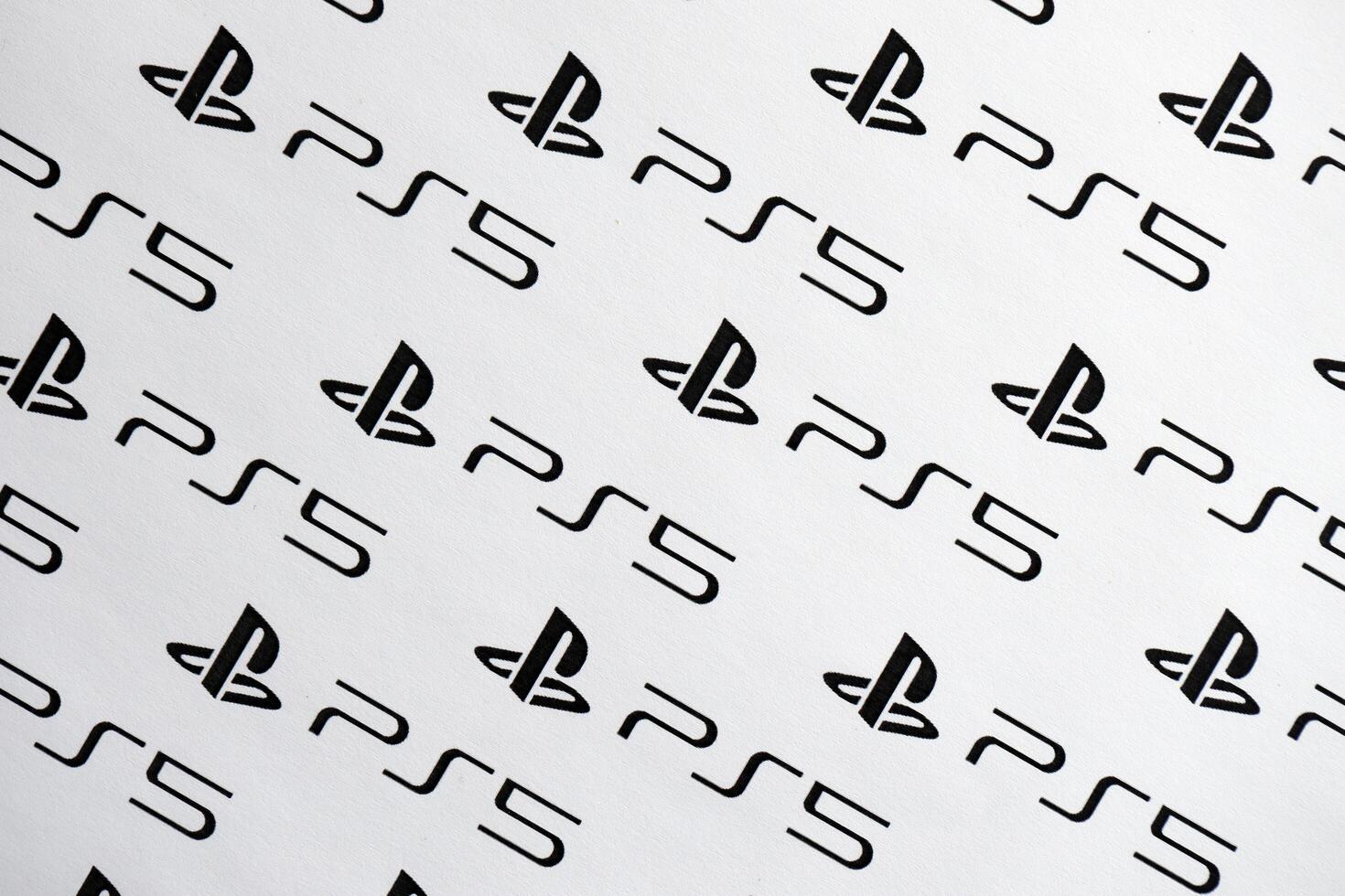 KYIV, UKRAINE - JUNE 26, 2024 Sony Playstation 5 console logo repeating many times on white paper background banner photo