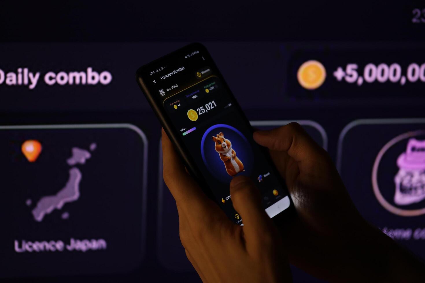 KYIV, UKRAINE - APRIL 20, 2024 Hamster Kombat telegram bot on smartphone screen. Hamster Kombat is a viral Telegram-based crypto game for earn HMSTR tokens by managing virtual crypto exchange photo