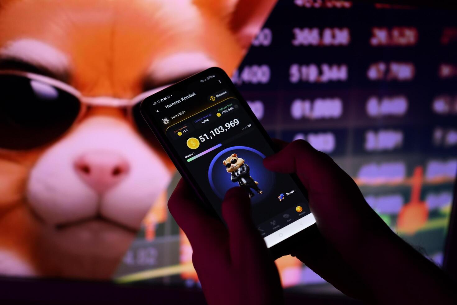 KYIV, UKRAINE - APRIL 20, 2024 Hamster Kombat telegram bot on smartphone screen. Hamster Kombat is a viral Telegram-based crypto game for earn HMSTR tokens by managing virtual crypto exchange photo