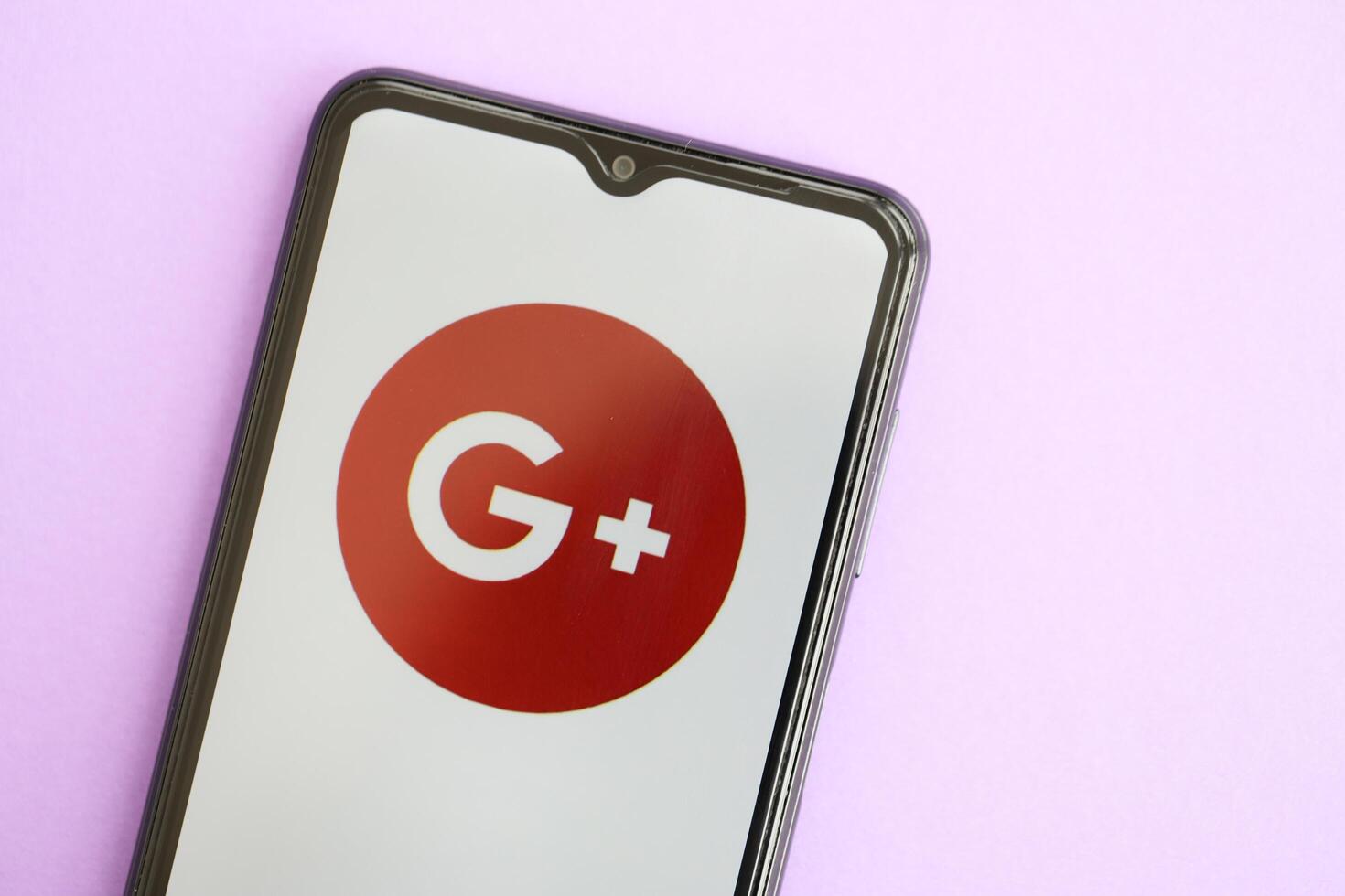 KYIV, UKRAINE - APRIL 1, 2024 Google Plus icon on smartphone screen on purple table photo