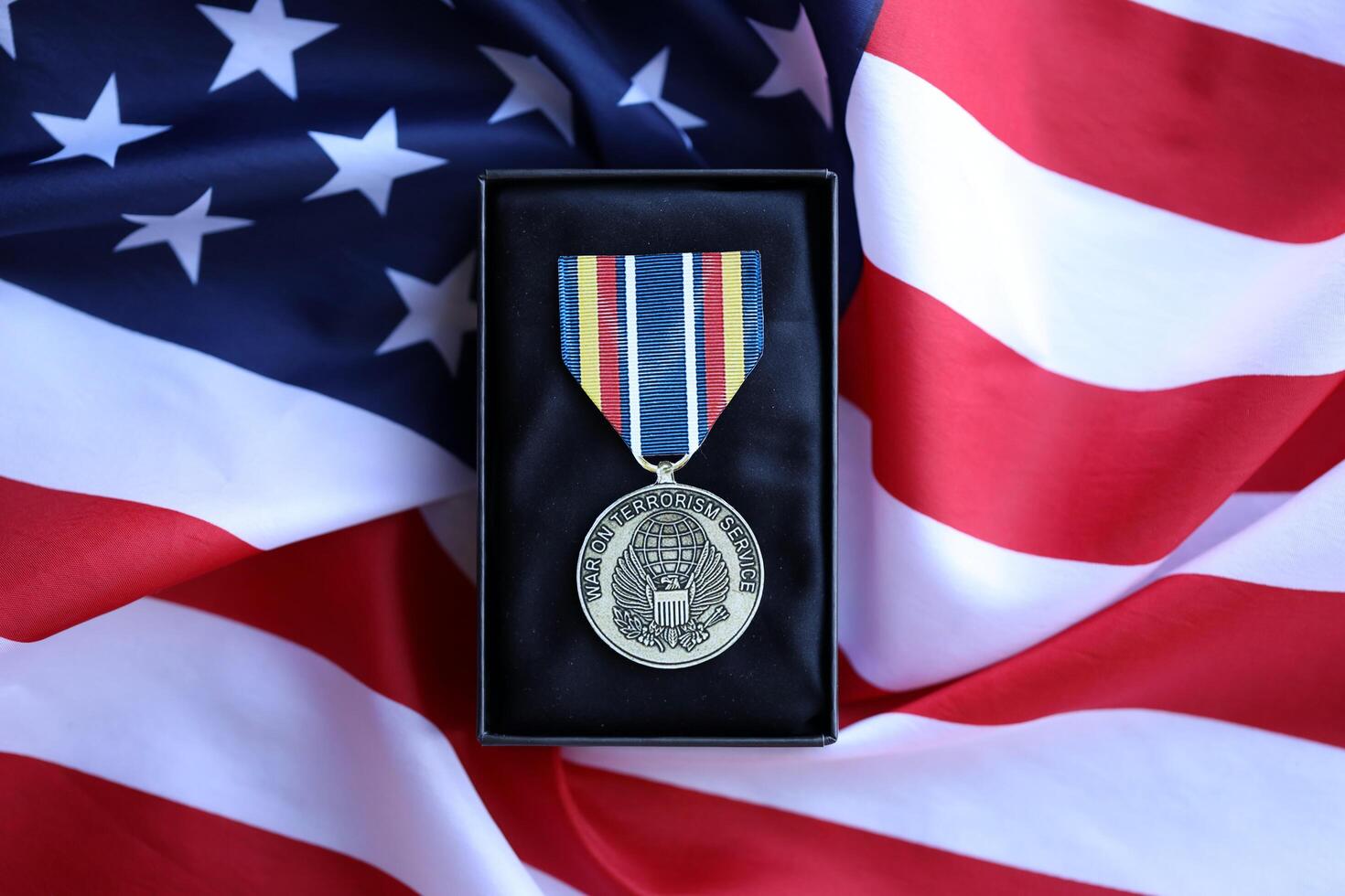 KYIV, UKRAINE - JULY 10, 2024 Global War on Terrorism Service medal. United States military award medal with ribbon and pin. Handmade paper theater props photo
