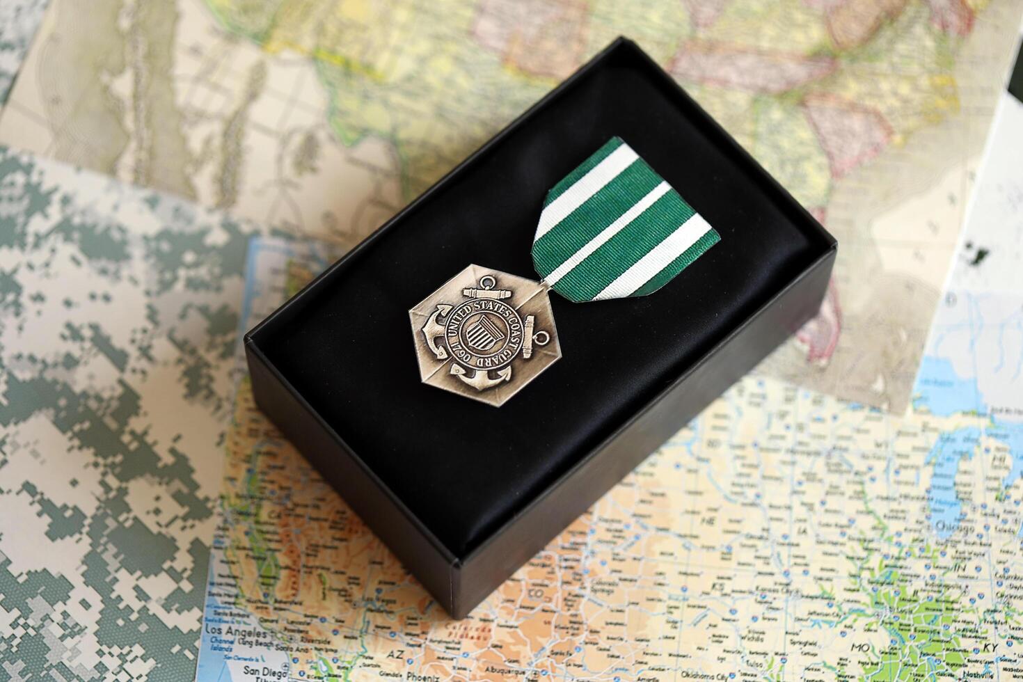 KYIV, UKRAINE - JULY 10, 2024 The Coast Guard Commendation medal. United States military award medal with ribbon and pin. Handmade paper theater props photo