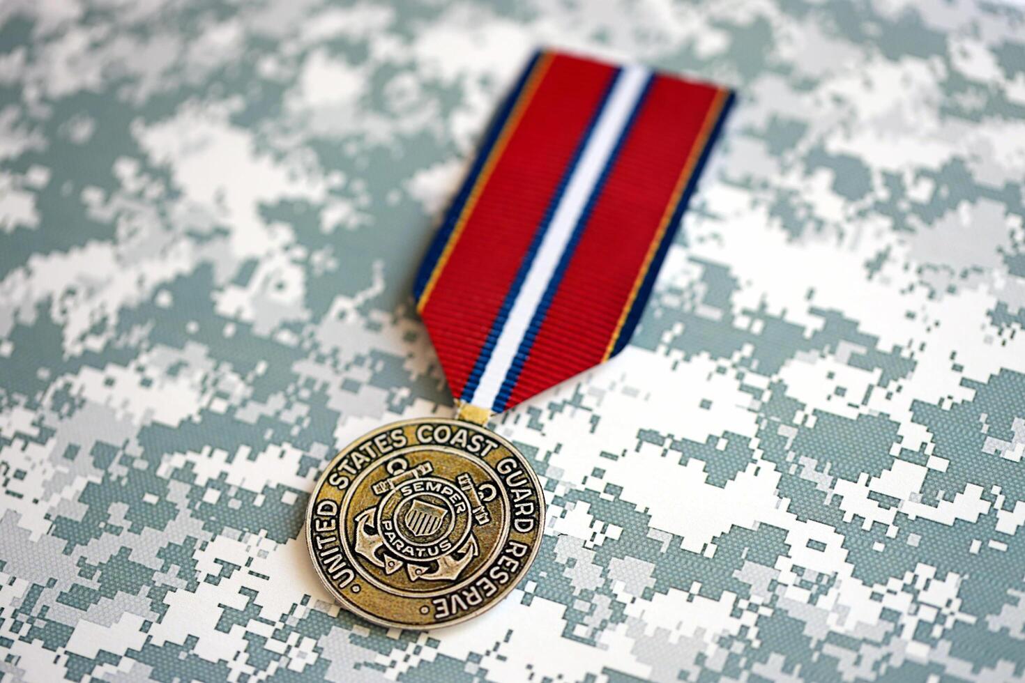 KYIV, UKRAINE - JULY 10, 2024 US Coast Guard Reserve Good Conduct medal. United States military award medal with ribbon and pin. Handmade paper theater props photo