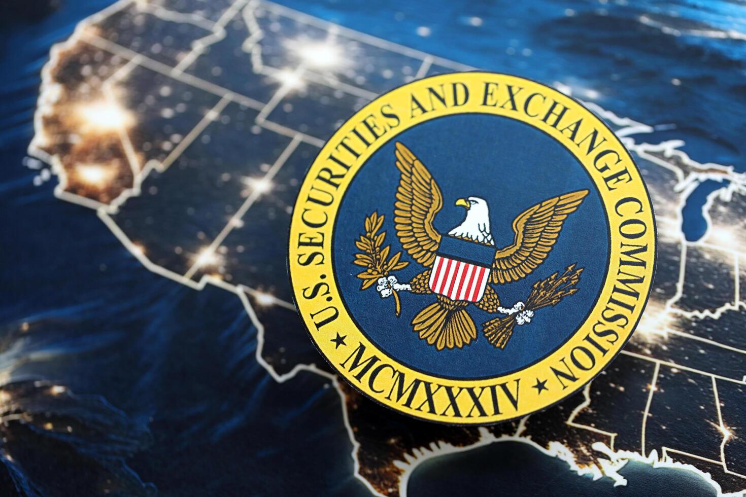 KYIV, UKRAINE - JUNE 26, 2024 U.S. Securities and Exchange Commission coat of arms on paper map of United States photo