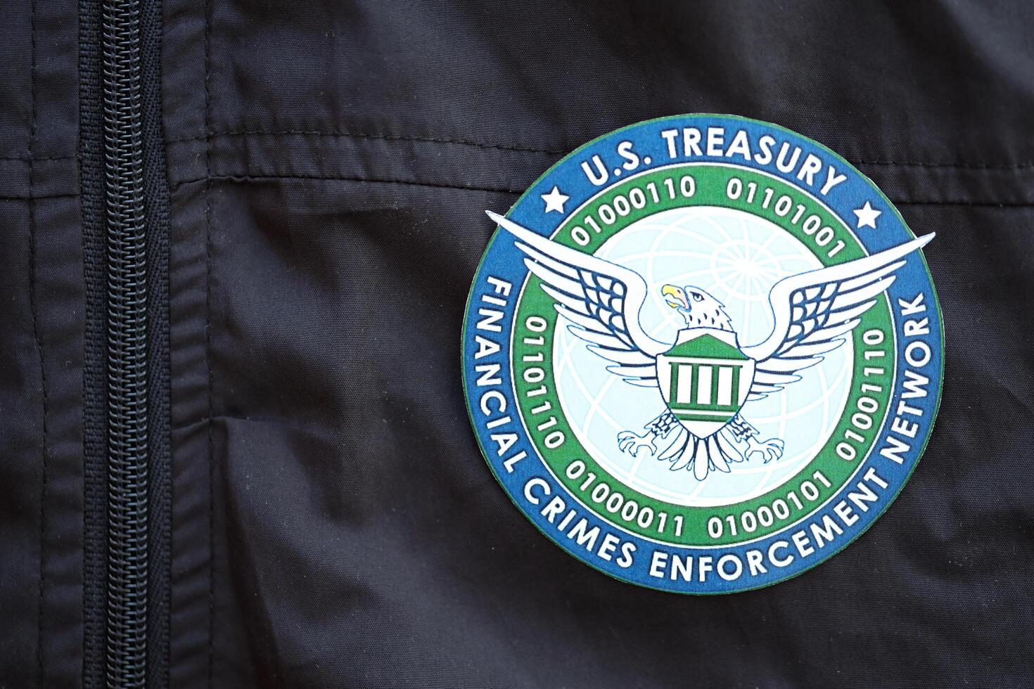 KYIV, UKRAINE - JUNE 26, 2024 U.S. Treasury Financial Crimes Enforcement Network coat of arms as pin on black uniform jacket photo