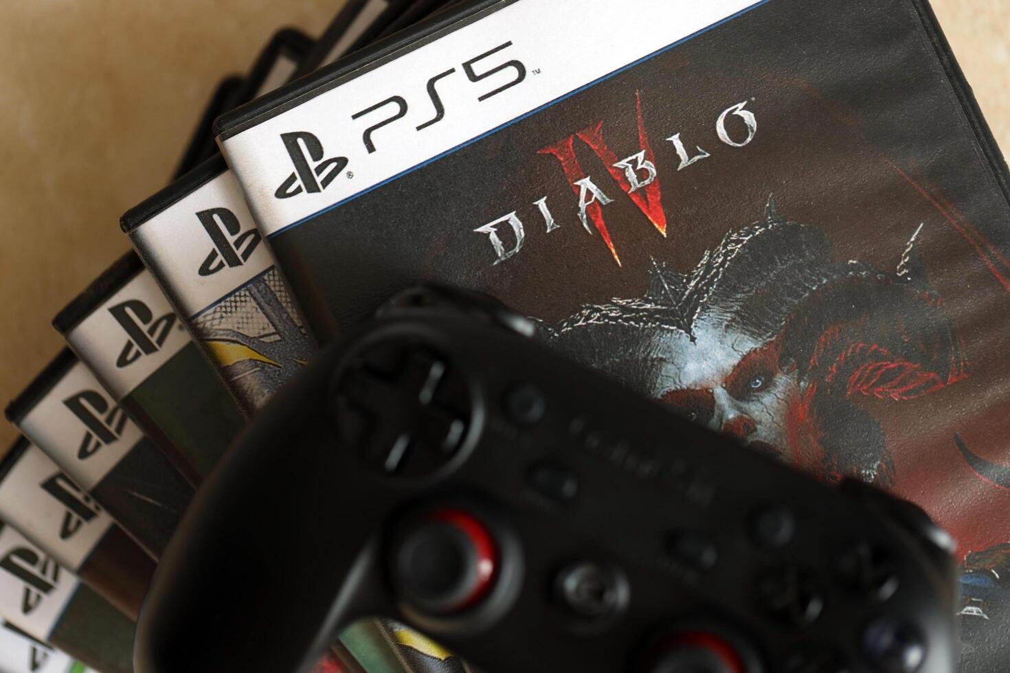 KYIV, UKRAINE - JUNE 26, 2024 Diablo 4 PS5 game disc box for console gaming. Popular game disc photo