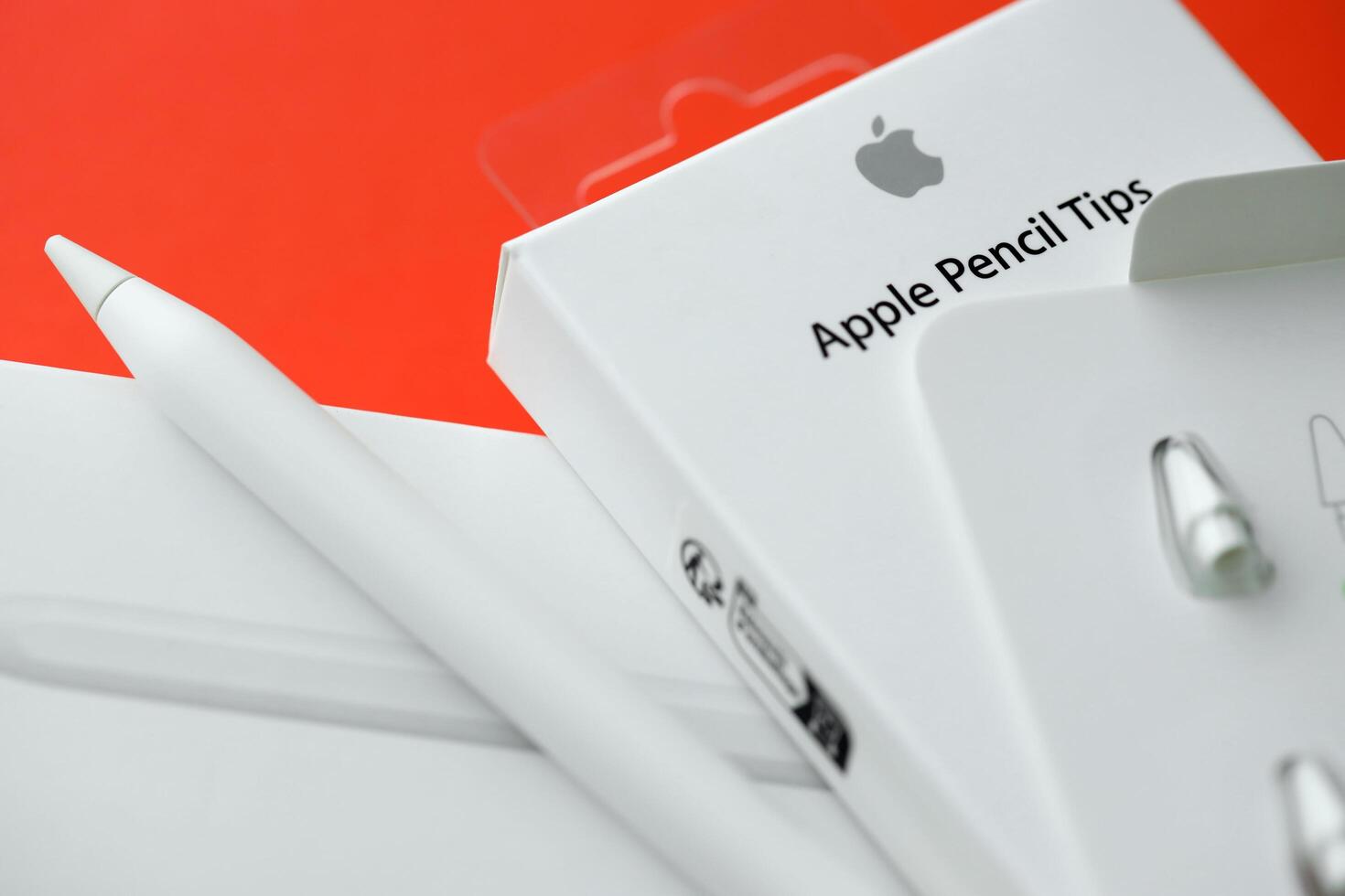 KYIV, UKRAINE - APRIL 20, 2024 Apple pencil tips for special apple pencil for drawing on iPad tablet on red background photo