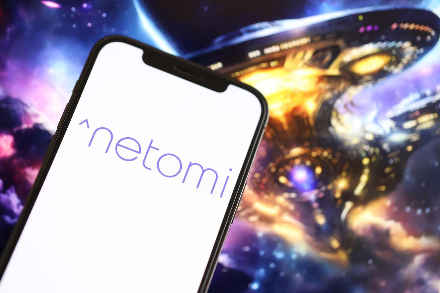 KYIV, UKRAINE - MARCH 17, 2024 Netomi logo on iPhone display screen with background of artificial intelligence futuristic image photo