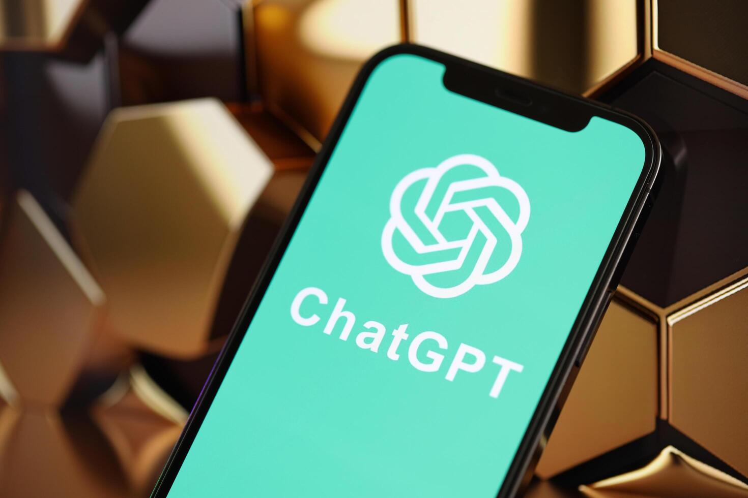 KYIV, UKRAINE - MARCH 17, 2024 ChatGPT logo on iPhone display screen with background of artificial intelligence futuristic image photo