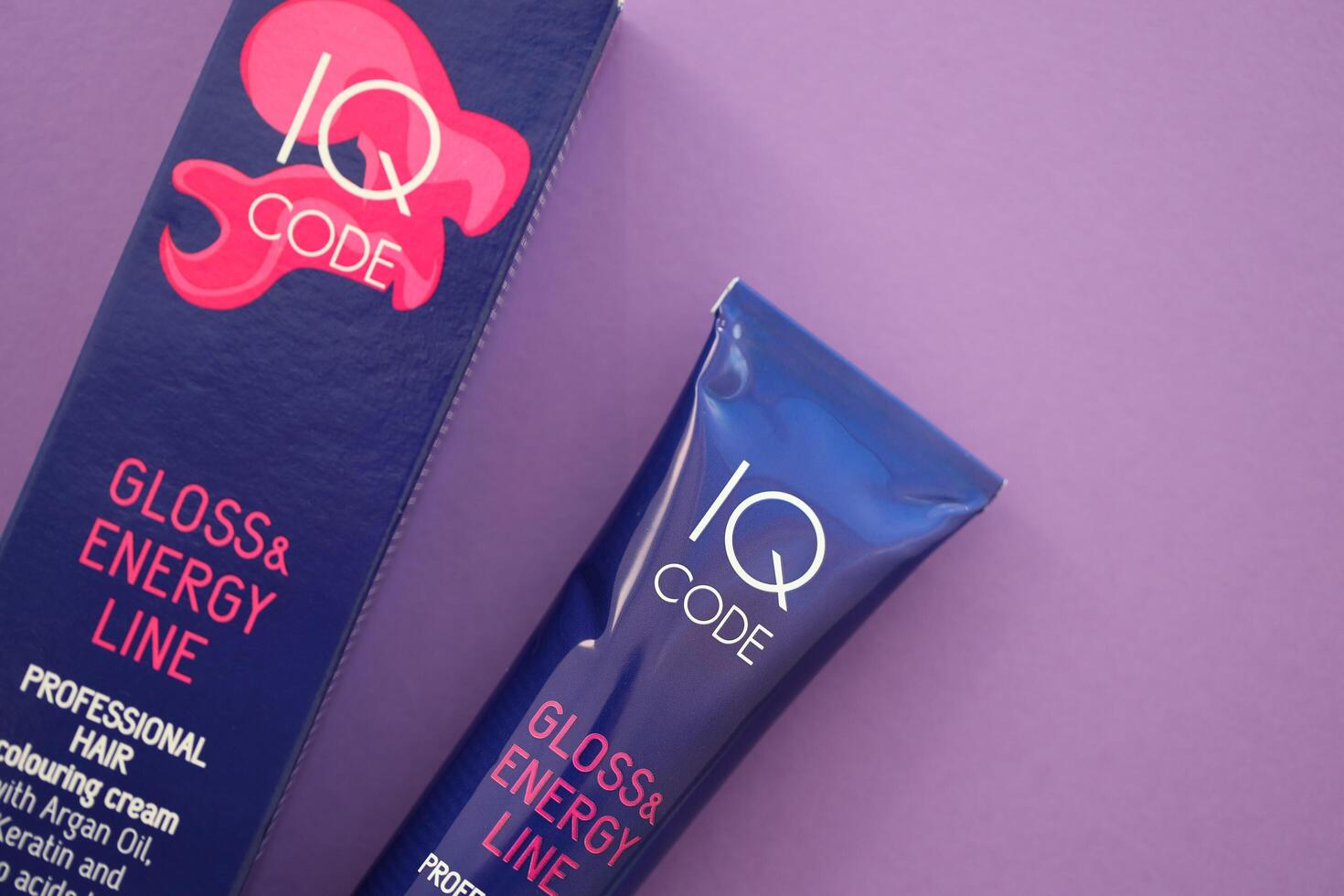 KYIV, UKRAINE - OCTOBER 31, 2023 Tube of IQ Code Gloss and Energy Line colorizer cream for hair photo
