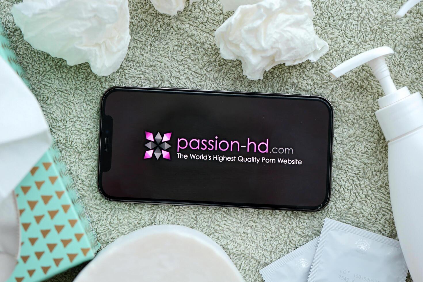 KYIV, UKRAINE - JANUARY 23, 2024 PassionHD adult content website logo on display of iPhone 12 Pro photo
