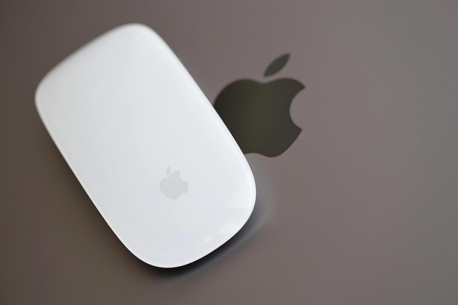 KYIV, UKRAINE - NOVEMBER 27, 2023 Apple Magic Mouse 3rd generation lies with grey MacBook 2021 photo