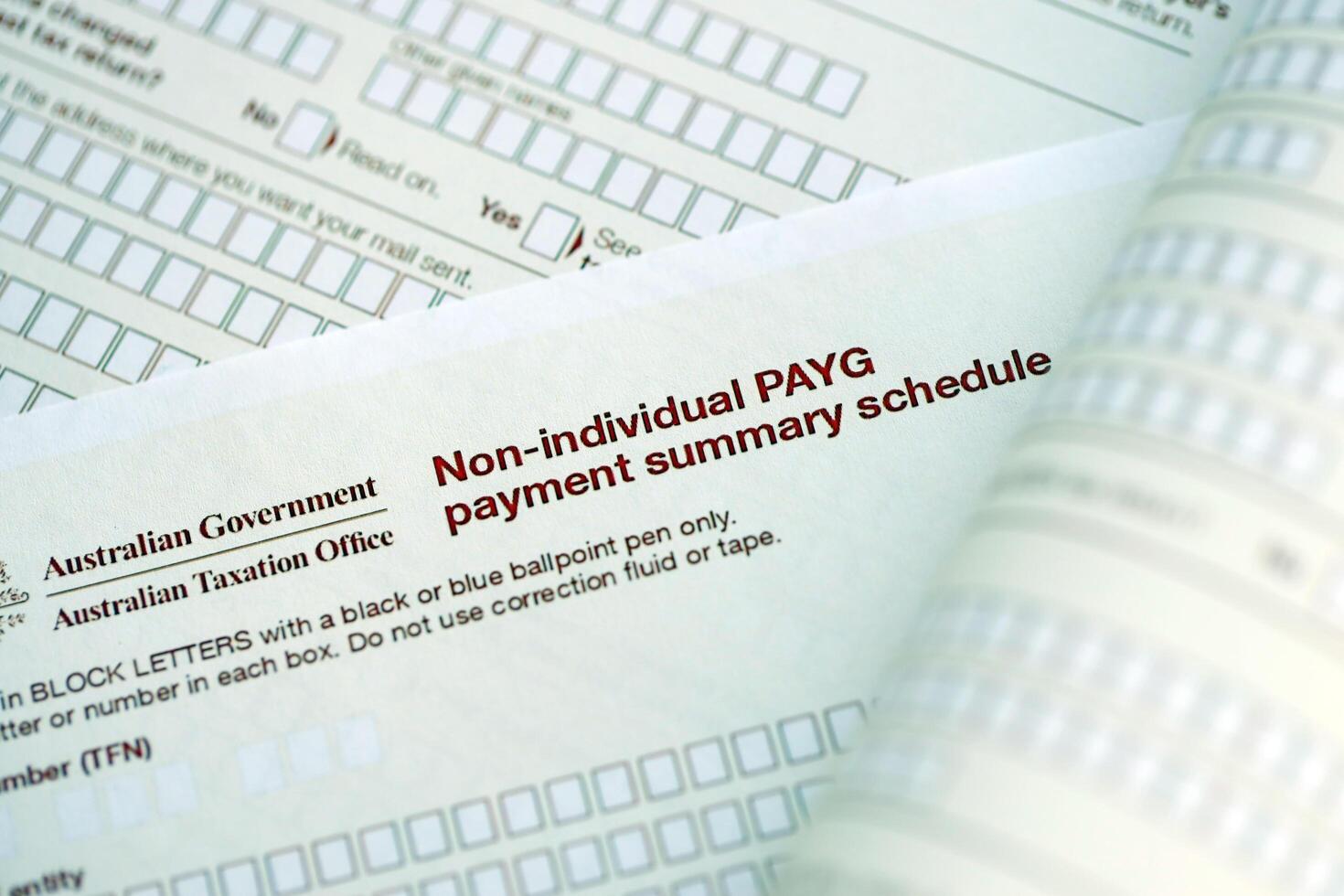 KYIV, UKRAINE - JULY 10, 2024 Australian Non-Individual PAYG payment summary schedule blank form lies on table of Australian Government taxation office photo