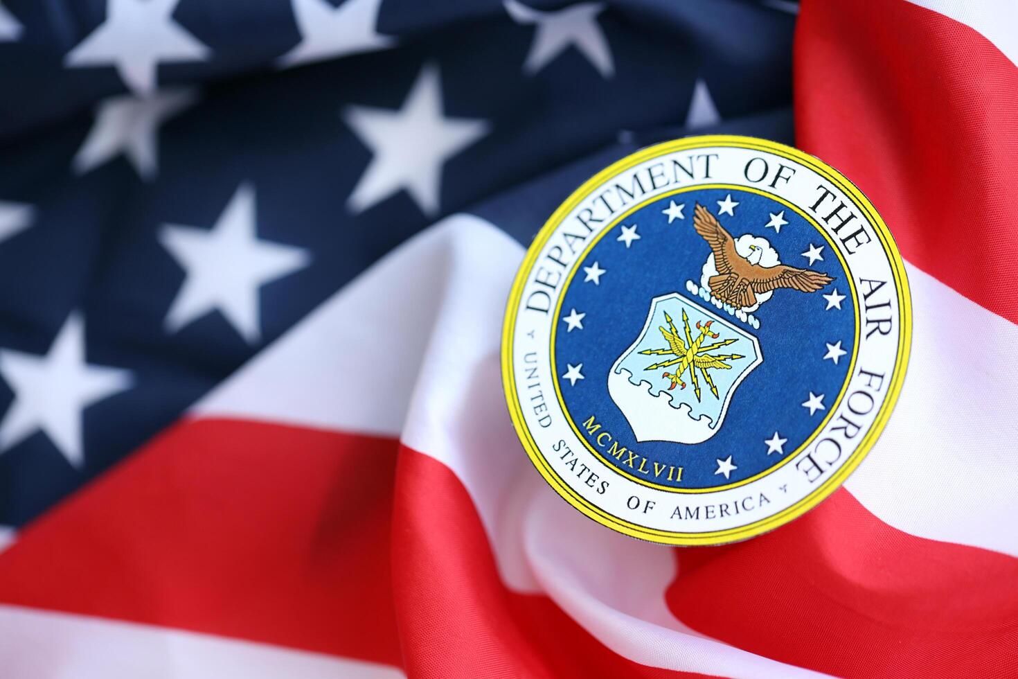KYIV, UKRAINE - JUNE 26, 2024 United States Department of the Air Force coat of arms sticker on folded US flag photo
