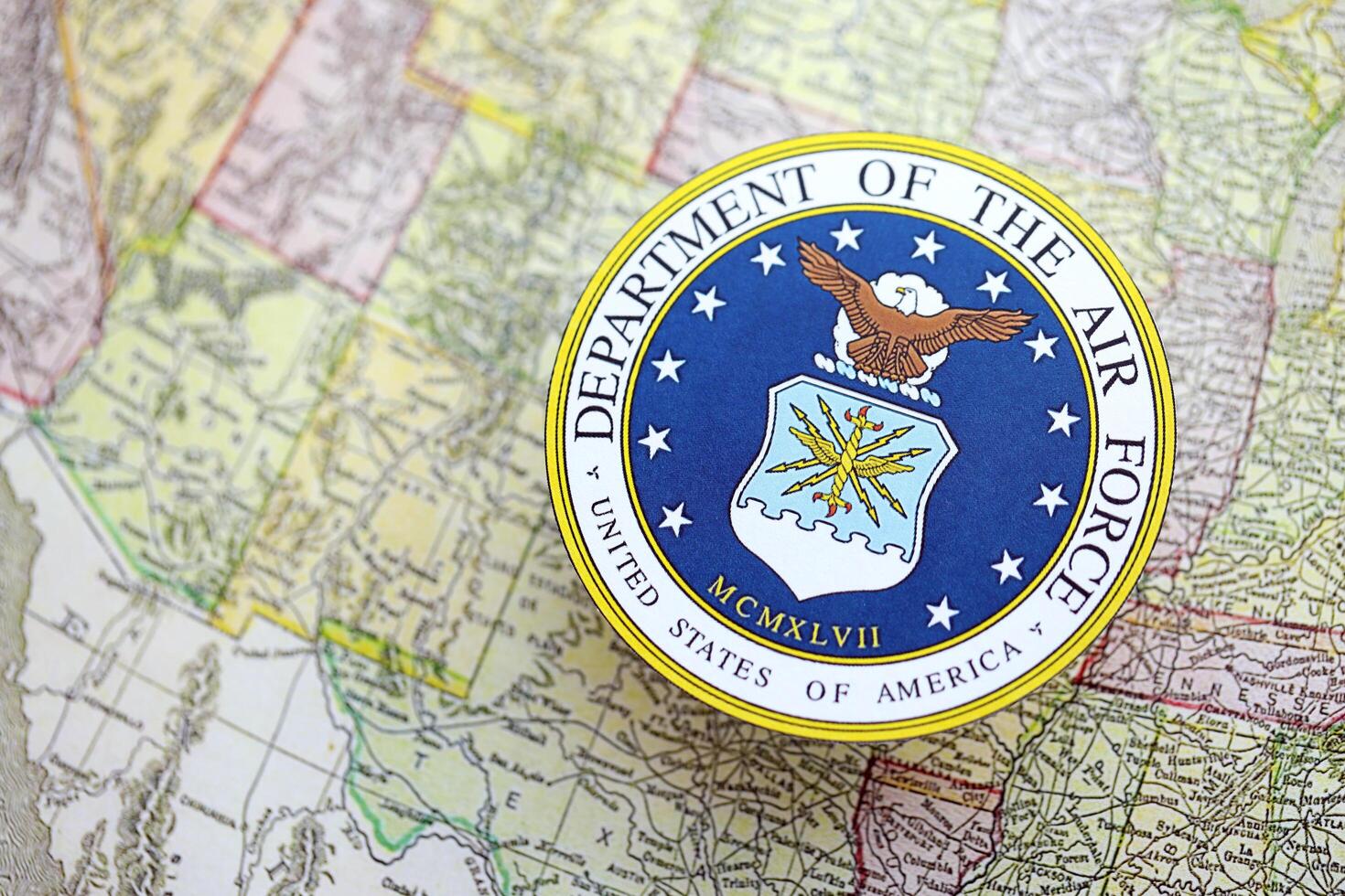 KYIV, UKRAINE - JUNE 26, 2024 United States Department of the Air Force coat of arms on paper map of United States photo