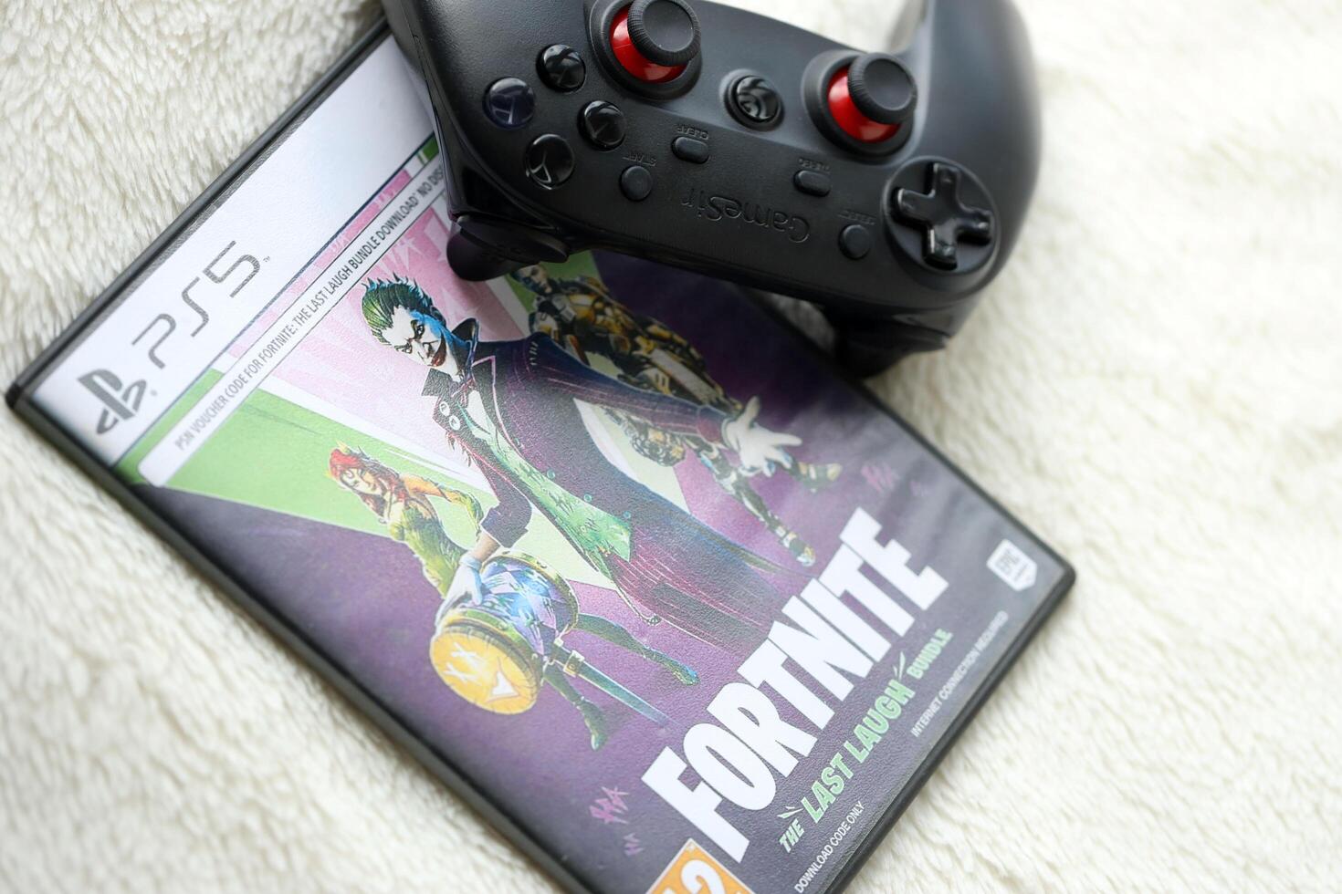 KYIV, UKRAINE - JUNE 26, 2024 Fortnite Last Laugh bundle PS5 game disc box for console gaming. Popular game disc photo