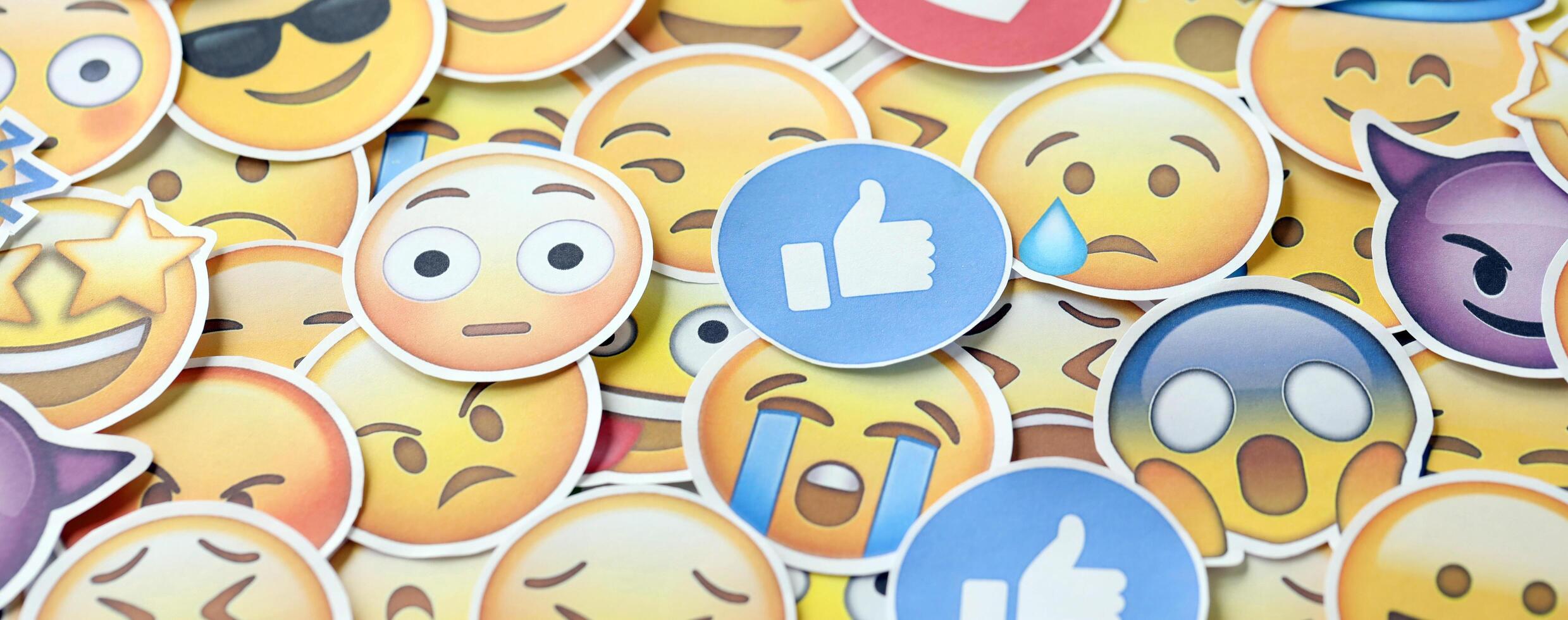 KYIV, UKRAINE - APRIL 20, 2024 Large set of stickers with Emoji yellow faces. Emoji is a pictogram or smiley embedded in text and used in electronic messages photo