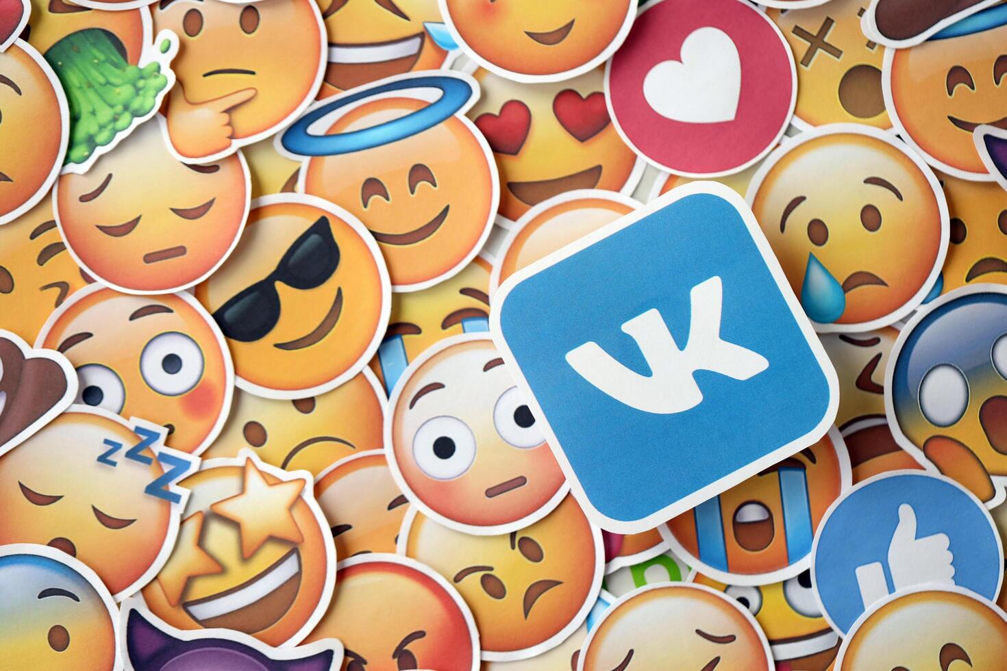 KYIV, UKRAINE - APRIL 20, 2024 VK logo and large set of stickers with Emoji yellow faces. Emoji is a pictogram or smiley embedded in text and used in electronic messages photo