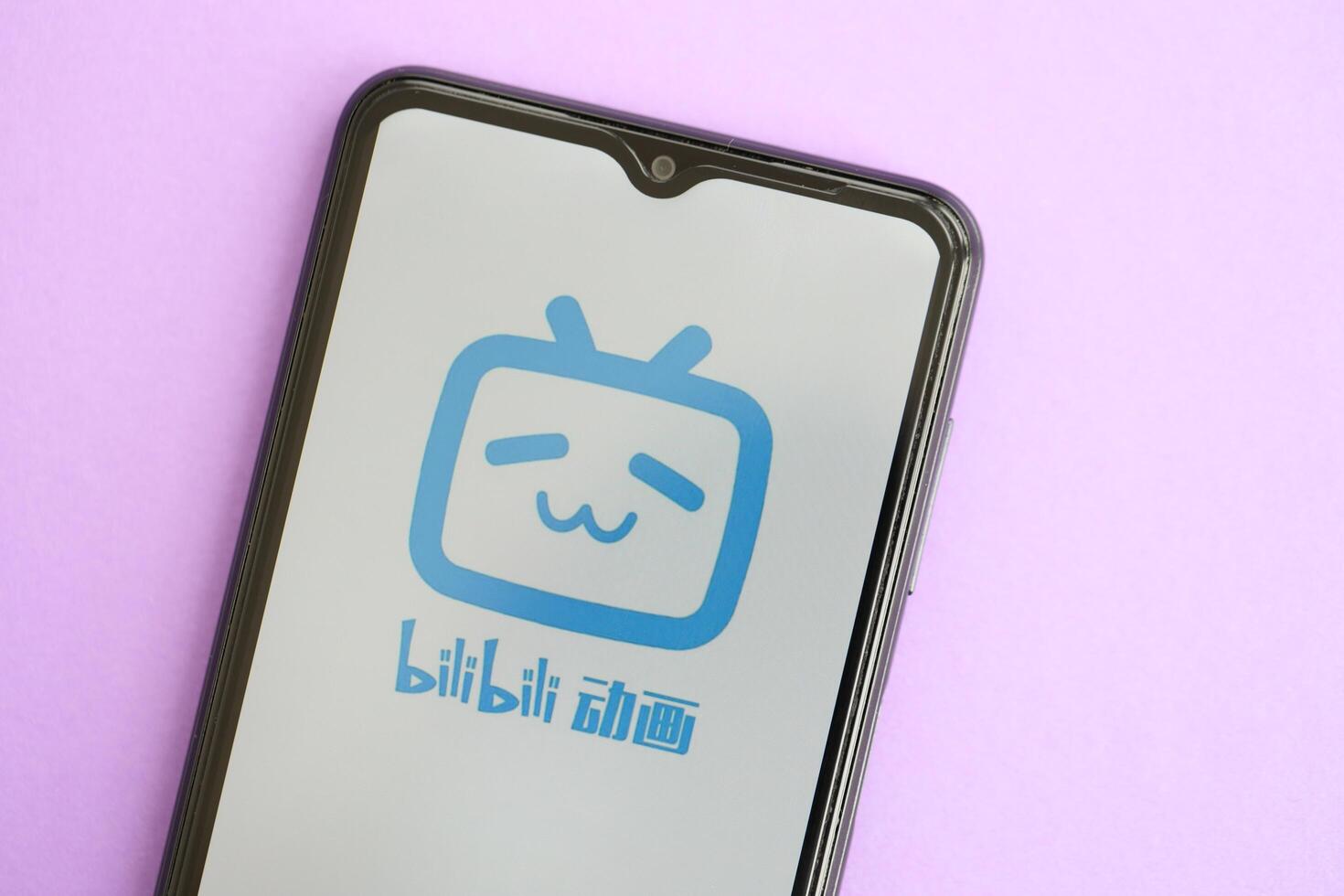 KYIV, UKRAINE - APRIL 1, 2024 Bilibili icon on smartphone screen on purple table photo