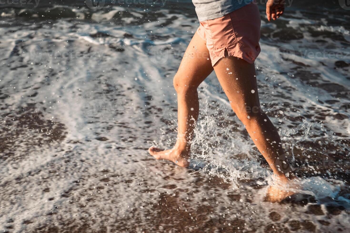 Small waves that reach the shore of the Mediterranean Sea and collide with the runner's feet. photo