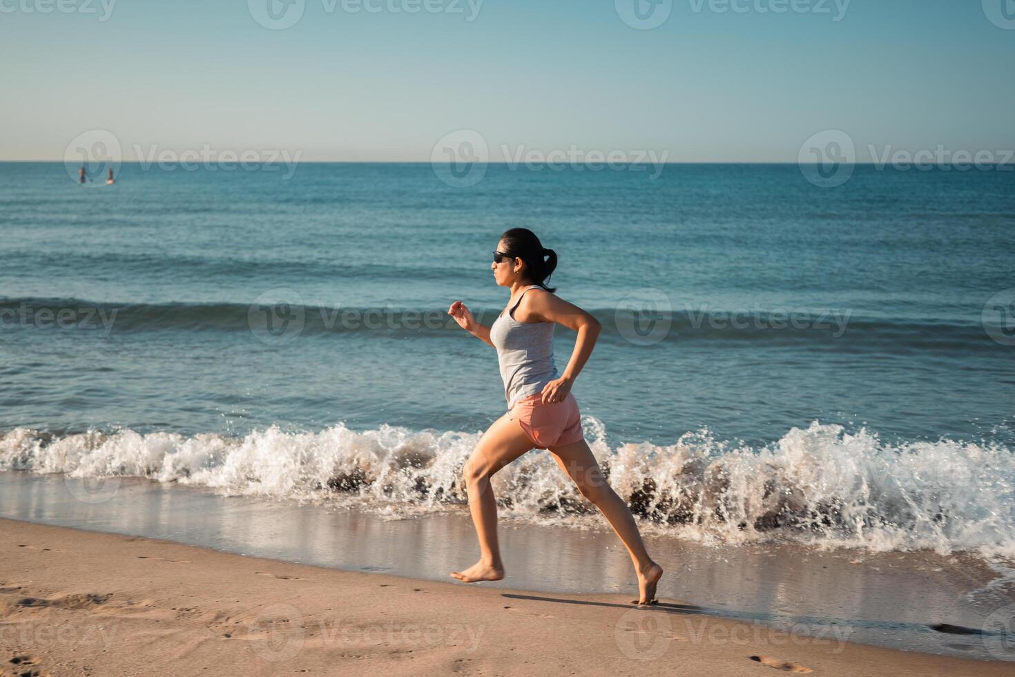 Fitness enthusiast running on the beach, harnessing the beauty and serenity of the coastal environment. photo
