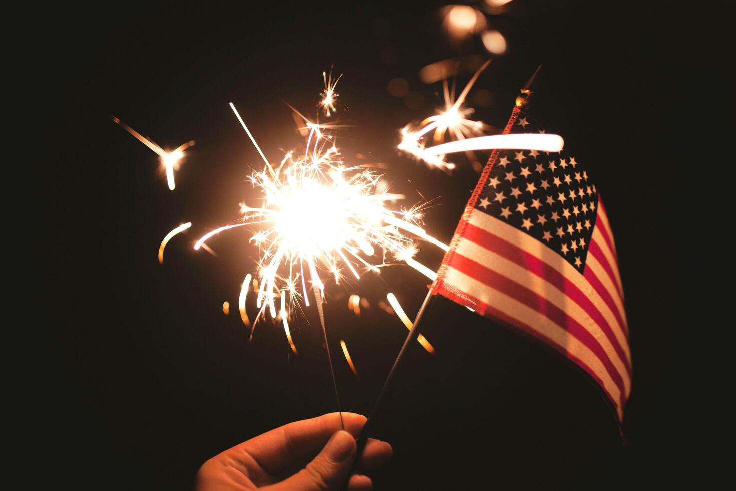 Elegant gold background with bright fireworks in sky photo