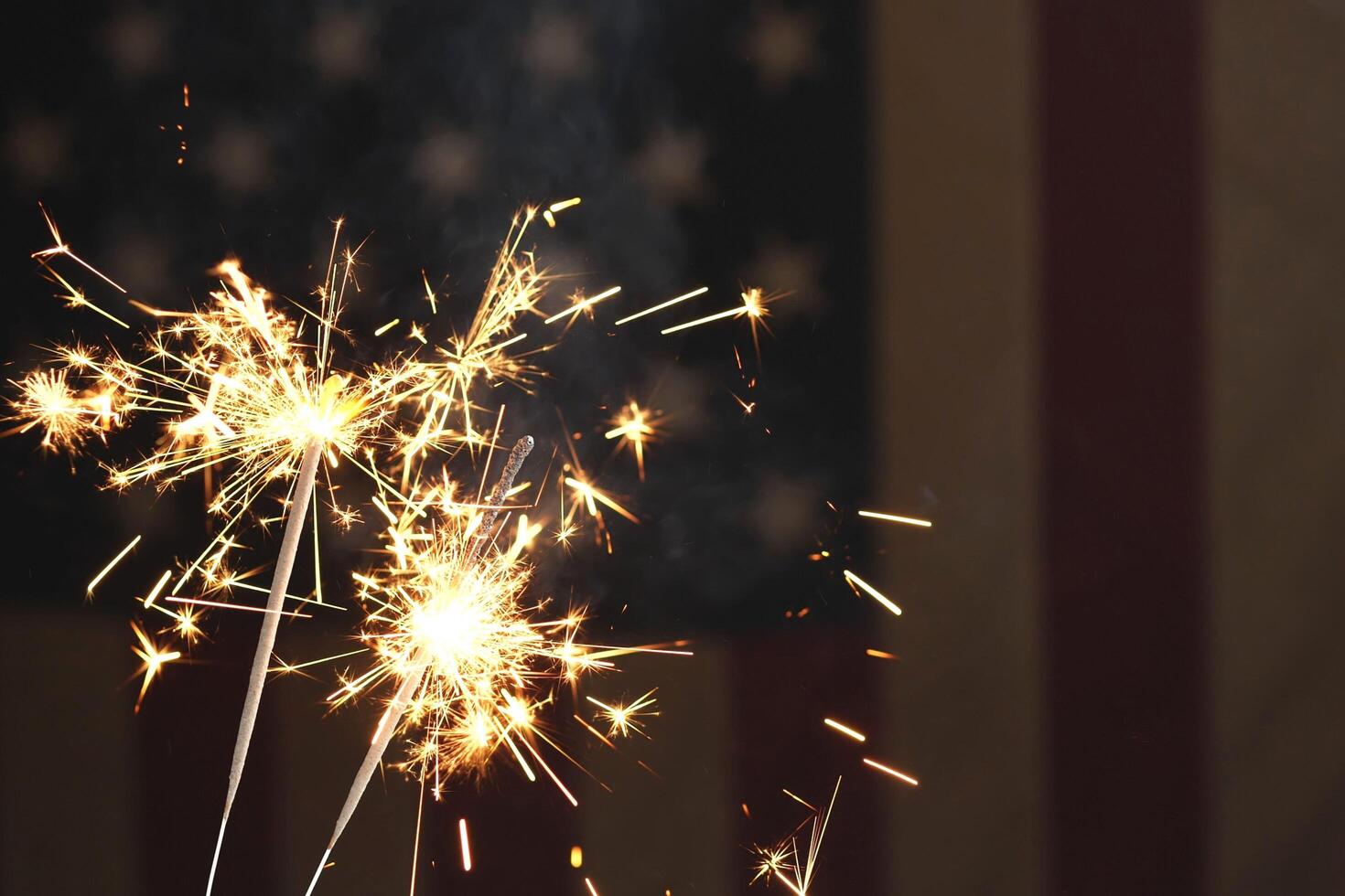 Elegant gold background with bright fireworks in sky photo