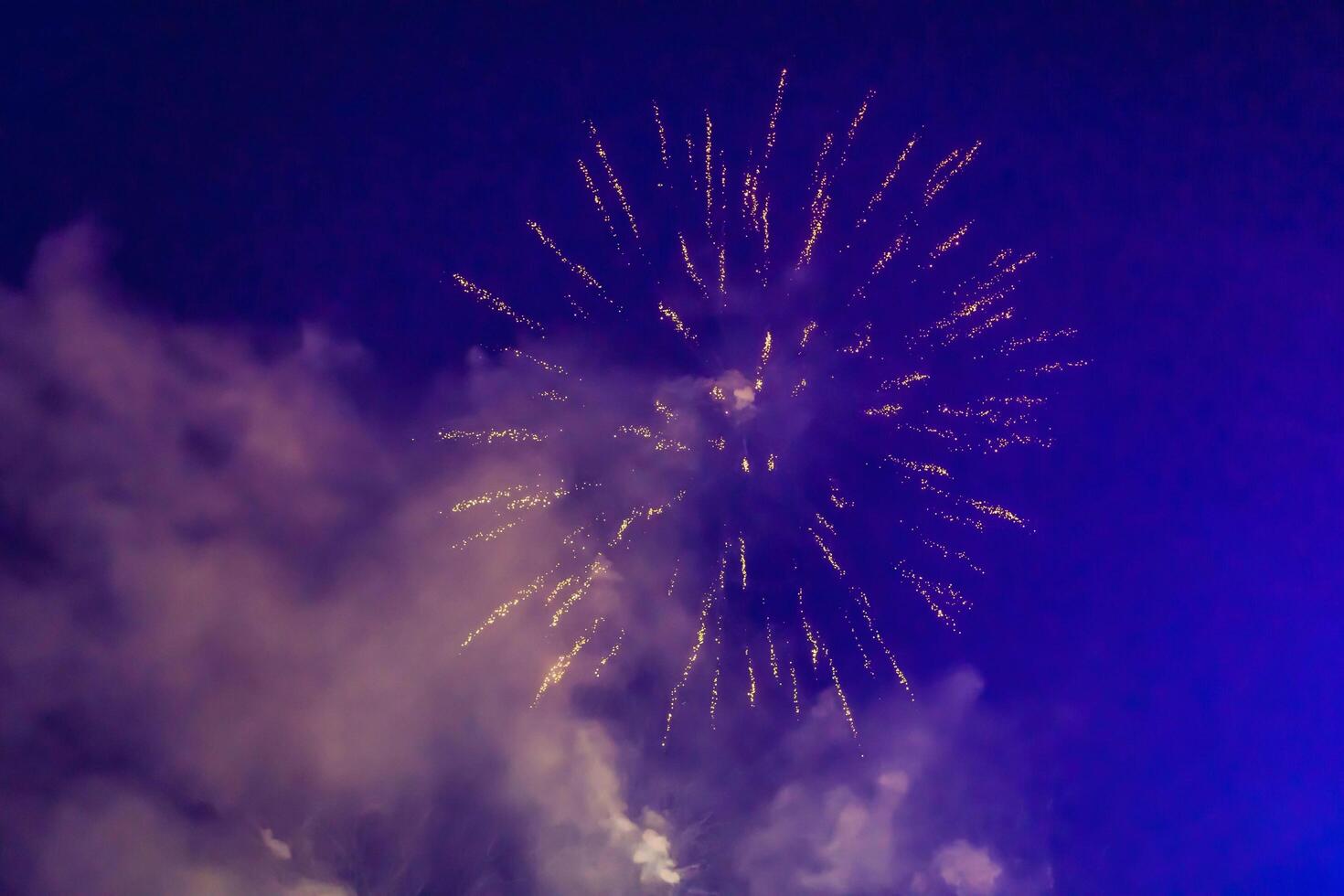 Elegant gold background with bright fireworks in sky photo