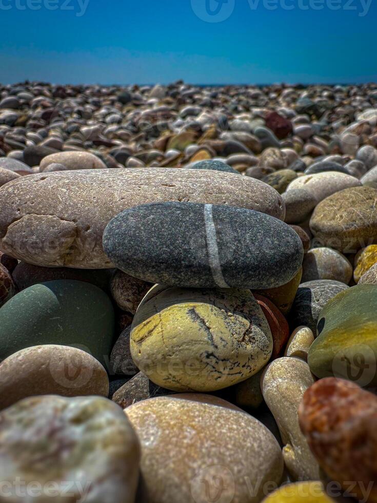 Multi-colored round rocks on Beach in Antalya, Turkey. Stone with a stripe photo