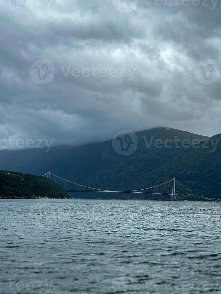 The Hardangerfjord is the fourth longest fjord in the world, and the second longest fjord in Norway. It is located in the Hardanger region. The fjord stretches 179 kilometres. The Hardanger Bridge photo