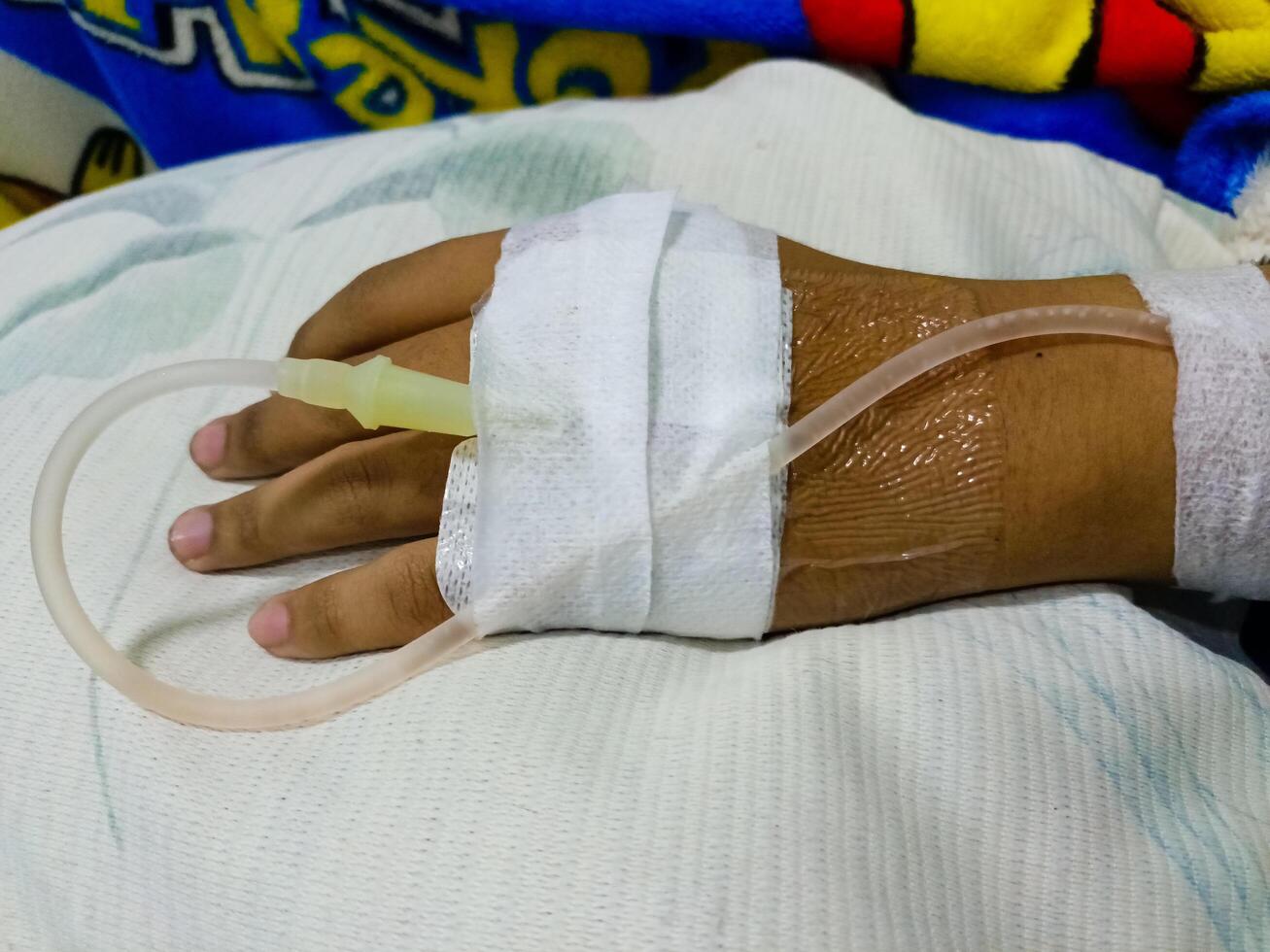 Asian man in hospital with intravenous saline. hand is being infused, infected with the virus, are lying and being treated in beds in hospitals. photo