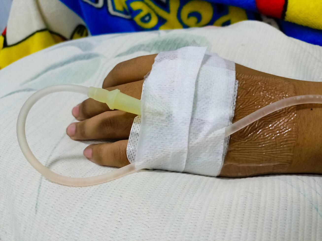 Asian man in hospital with intravenous saline. hand is being infused, infected with the virus, are lying and being treated in beds in hospitals. photo
